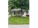 A charming one-story home with a front porch framed by a mature tree at 4521 Vernon Ave, Indianapolis, IN 46226