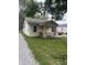 Quaint home featuring a cozy front porch and adjacent gravel driveway at 4521 Vernon Ave, Indianapolis, IN 46226