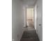 Hallway with wood-look tile floors and a view into another room with hardwood floors at 4521 Vernon Ave, Indianapolis, IN 46226