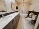 Bathroom with double sink vanity, modern fixtures, soaking tub, and tiled walls at 4635 Stansbury Ct, Indianapolis, IN 46254
