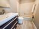 Bathroom featuring a modern vanity, a bathtub and shower, and neutral tile work at 4635 Stansbury Ct, Indianapolis, IN 46254