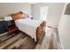 Charming bedroom featuring a wood-framed bed, stylish floors and natural light from a bright window at 4635 Stansbury Ct, Indianapolis, IN 46254