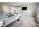 Cozy bedroom featuring a queen-sized bed, a flat-screen TV, and plush gray carpeting at 4635 Stansbury Ct, Indianapolis, IN 46254