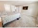 Spacious bedroom featuring plush carpet and a large window for natural light at 4635 Stansbury Ct, Indianapolis, IN 46254