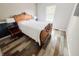 Bright bedroom with hardwood floors, an antique bed frame, and large window at 4635 Stansbury Ct, Indianapolis, IN 46254