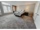 Bedroom with large windows, plush carpeting, neutral walls, ceiling mounted lighting, and closet storage at 4635 Stansbury Ct, Indianapolis, IN 46254
