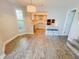 Open dining area leading to the kitchen, complete with hardwood floors and natural light at 4635 Stansbury Ct, Indianapolis, IN 46254