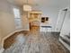 Dining room leading to a kitchen, featuring hard wood floors and natural light at 4635 Stansbury Ct, Indianapolis, IN 46254