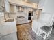 Modern white kitchen with stainless steel appliances, gas range, and breakfast bar at 4635 Stansbury Ct, Indianapolis, IN 46254