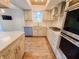 Updated kitchen with stainless steel appliances, light cabinets, and a corner window at 4635 Stansbury Ct, Indianapolis, IN 46254