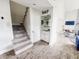 Open floor plan with stairs, a wet bar, and a view into the living room at 4635 Stansbury Ct, Indianapolis, IN 46254