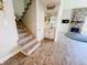 Staircase and built-in bar area lead into the living room with stone fireplace at 4635 Stansbury Ct, Indianapolis, IN 46254