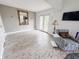 Bright room features a large mirror, stylish armchair, and walkout access at 4635 Stansbury Ct, Indianapolis, IN 46254