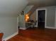 Finished attic space with hardwood floors, desk nook, and bright lighting, perfect for a home office or den at 4747 Guion Rd, Indianapolis, IN 46254