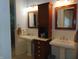 Elegant bathroom features pedestal sinks, and custom cabinet for storage at 4747 Guion Rd, Indianapolis, IN 46254