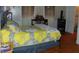 Bedroom featuring yellow comforter, bookshelf, and closet access at 4747 Guion Rd, Indianapolis, IN 46254