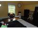 Bedroom with hardwood floors, whimsical wall art, and a window view at 4747 Guion Rd, Indianapolis, IN 46254