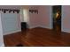 Bedroom featuring hardwood floors, unique wall art, and natural light from the window at 4747 Guion Rd, Indianapolis, IN 46254
