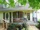 Charming front porch with ample space for seating and relaxing with a welcome sign at the door at 4747 Guion Rd, Indianapolis, IN 46254