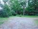 Wide front yard is covered with shade trees and leads to a lush yard at 4747 Guion Rd, Indianapolis, IN 46254