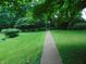 Stone walkway leading to home with landscaped yard and mature trees at 4747 Guion Rd, Indianapolis, IN 46254