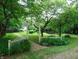 Landscaped yard with a white picket fence, stone path, and hammock at 4747 Guion Rd, Indianapolis, IN 46254