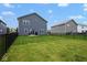 Fenced-in backyard with green grass and a clear view of the two-story home's rear elevation at 4832 W Safford Dr, New Palestine, IN 46163