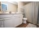 Neutral bathroom includes a white vanity, modern fixtures, a toilet, and a shower with a curtain at 4832 W Safford Dr, New Palestine, IN 46163