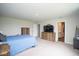 Bedroom featuring a full sized bed, dresser, TV, and a bathroom doorway at 4832 W Safford Dr, New Palestine, IN 46163