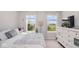 Bright bedroom with neutral walls, two windows, and a dresser, creating a cozy atmosphere at 4832 W Safford Dr, New Palestine, IN 46163