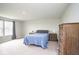 Spacious primary bedroom with large bed, natural light, and wood dressers at 4832 W Safford Dr, New Palestine, IN 46163