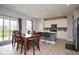 Open floor plan with dining area leading to a modern kitchen and sliding glass doors to the outside at 4832 W Safford Dr, New Palestine, IN 46163