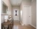 Inviting entryway with wood floors, stylish console table, mirror, and a view of the front door at 4832 W Safford Dr, New Palestine, IN 46163