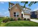 Exterior showcasing brick and siding details, framed by lush greenery, and a glimpse of neighboring houses at 4832 W Safford Dr, New Palestine, IN 46163