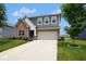 Charming two-story home with brick and siding, featuring a well-manicured lawn and attached two-car garage at 4832 W Safford Dr, New Palestine, IN 46163