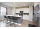 Modern kitchen featuring white cabinets, stainless steel appliances, and a stylish island with seating at 4832 W Safford Dr, New Palestine, IN 46163