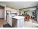 Spacious kitchen with white cabinets, stainless steel appliances, and open view to the dining and living area at 4832 W Safford Dr, New Palestine, IN 46163