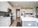 Modern kitchen featuring white cabinets, stainless steel appliances, and a stylish island with seating at 4832 W Safford Dr, New Palestine, IN 46163