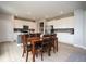 Bright kitchen and dining area with white cabinets, stainless steel appliances, and wood dining table at 4832 W Safford Dr, New Palestine, IN 46163