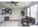Cozy living room featuring a fireplace, large TV, and comfortable brown leather reclining sofa at 4832 W Safford Dr, New Palestine, IN 46163