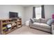 Comfortable living room features a media center, seating, and natural light at 4832 W Safford Dr, New Palestine, IN 46163