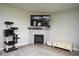 Cozy living room showcasing a fireplace, mounted TV, cat tree, and a neutral color scheme at 4832 W Safford Dr, New Palestine, IN 46163