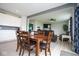 Open concept dining and living area featuring a wood dining table and brown reclining sofas at 4832 W Safford Dr, New Palestine, IN 46163