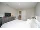 Spacious main bedroom featuring grey dresser, tv and opening to living area at 4832 W Safford Dr, New Palestine, IN 46163