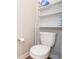 Close up of a standard white toilet with shelving for storage and toilet paper at 4832 W Safford Dr, New Palestine, IN 46163