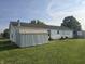 Spacious backyard featuring a well-maintained lawn and a storage shed at 496 Tague St, Greenfield, IN 46140