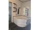 Bathroom featuring a large soaking tub and double mirrors at 496 Tague St, Greenfield, IN 46140