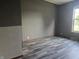 Bedroom featuring hardwood floors, neutral walls, and bright light from the window at 496 Tague St, Greenfield, IN 46140