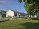 Well-manicured lawn and landscaping compliment this home's charming exterior at 496 Tague St, Greenfield, IN 46140