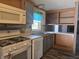 Well-lit kitchen with wood-look flooring, stainless steel sink, and modern appliances at 496 Tague St, Greenfield, IN 46140